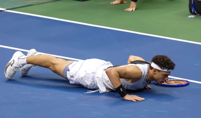 Ben Shelton Lies on the Court During a US Open Match