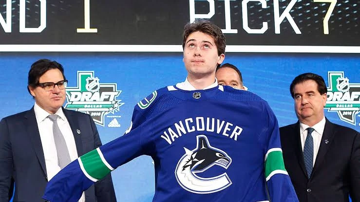 Quinn Hughes Puts On a Vancouver Canucks Jersey at the NHL Draft