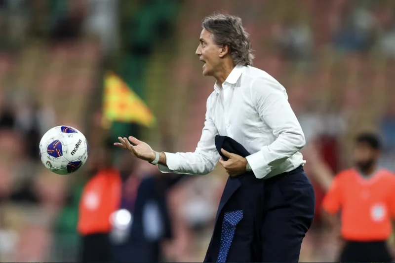 Roberto Mancini Catches the Ball on the Touchline During a Match