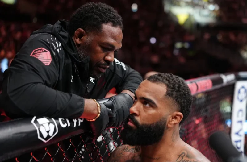 A Cornerman Instructs a UFC Fighter at the Cage Between Rounds